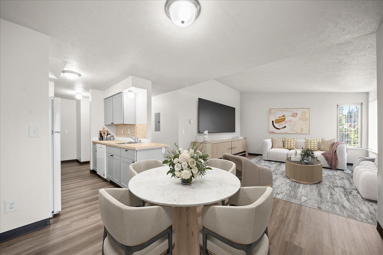 StagedLiving room and kitchen from dining area